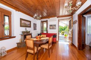 a dining room with a wooden table and chairs at Kouvlaki Effie's Place in Afissos in Afissos