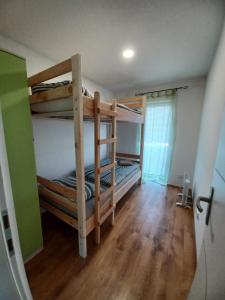 a room with two bunk beds and a wooden floor at Aquas AP in Petrijanec