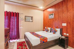 a bedroom with a bed in a room at FabExpress Limewood in Dehradun