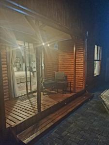 a view of a house with a wooden porch at Meraki Country Manor in Lanseria