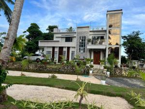 a house with a car parked in front of it at D ARC Leisure Home By The Sea in Panglao