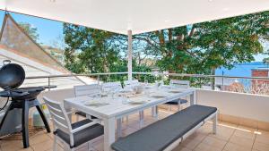 a white table and chairs on a balcony at Dutchmans Bay Escape 45A Thurlow in Nelson Bay