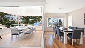 a dining room with a table and chairs at Dutchmans Bay Escape 45A Thurlow in Nelson Bay