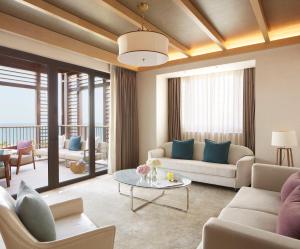 a living room with couches and a table at Jumeirah Al Naseem Dubai in Dubai