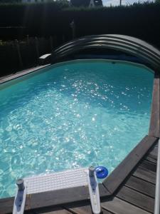 una piscina con una rampa en el agua en Gite Appartement "Le bel étage" jacuzzi piscine 6 Personnes, en Godinne