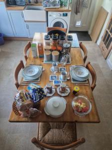 a wooden table with food on it in a kitchen at Old Coach House in Birchington