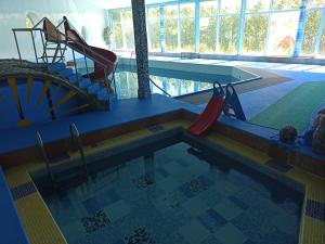 a swimming pool with a slide and a water slide at Hotel Laagna in Laagna