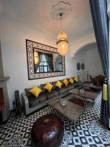 a living room with a couch and a mirror at Riad CK Medina in Marrakesh