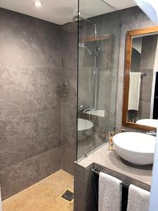 a bathroom with a sink and a glass shower at Riad CK Medina in Marrakech