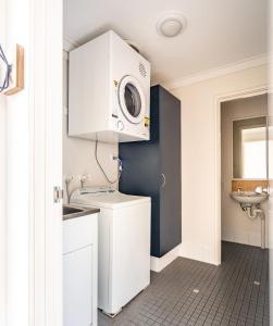 a bathroom with a sink and a microwave at Forestview Apartment Margaret River in Margaret River Town