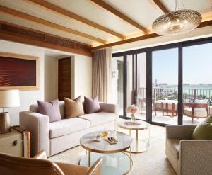 a living room with a couch and a table at Jumeirah Al Naseem Dubai in Dubai