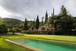 a house with a swimming pool in a yard at Mas Corbella in Alcover