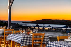 a table with a view of the beach at sunset at Chrysomare Beach Hotel & Resort in Ayia Napa