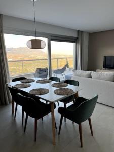 sala de estar con mesa, sillas y sofá en Luxury penthouse with sea view in La Cala Golf Resort, en La Cala de Mijas