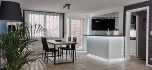 a kitchen with a table and chairs in a room at Résidence Gabrielle centre de Spa in Spa