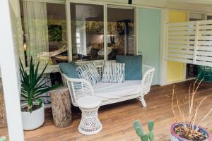 坎貝爾港的住宿－奧考港口汽車旅館，一个带白色椅子和植物的门廊
