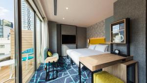Postel nebo postele na pokoji v ubytování JR East Hotel Mets Premier Akihabara
