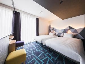 Postel nebo postele na pokoji v ubytování JR East Hotel Mets Premier Akihabara