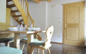 a dining room with a wooden table and chairs at Apartments Etruska in Santa Cristina in Val Gardena +18 photos