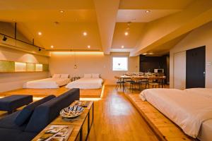um quarto de hotel com duas camas e uma sala de jantar em D-and Stay 5 Resort Okinawa em Urazoe