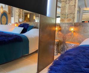 a bedroom with two beds and a stone wall at PRIVATE ROOM & SPA avec Jacuzzi privatif in Lorgues