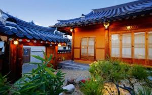 an asian style house with a garden in front of it at Full of Love Guesthouse in Jeonju