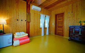 a living room with wooden walls and a room with a table at Full of Love Guesthouse in Jeonju