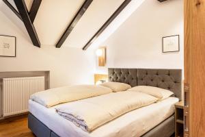 a bed in a room with white walls at Residence Skutial App Santner in Castelrotto