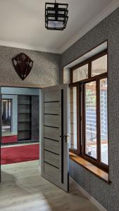 a room with a door with a window and a mirror at Nihol in Tashkent