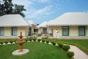 a man standing in front of a house with a fountain at Tajview Agra-IHCL SeleQtions in Agra