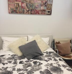 a bedroom with a bed with a black and white comforter at Cool Apartment, Central To Everything, share with 2x Bulldogs in Auckland