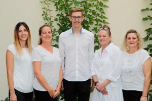 a man standing next to a group of women at Apartmenthaus Nr 1 in Lienz