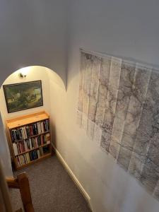 a room with a book shelf and a large map on the wall at The Old Pie Shop Hebden Bridge in Hebden Bridge