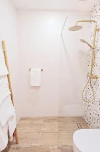 a bathroom with a toilet and a glass shower at Meraki: tu hogar en Frigiliana in Frigiliana