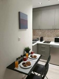 a kitchen with a table with two plates of food on it at Byronico Acropolis Apartment by MPS in Athens