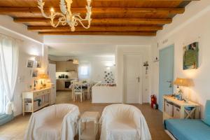 ein Wohnzimmer mit einem Kronleuchter und eine Küche in der Unterkunft Irilena's guest house in Faros