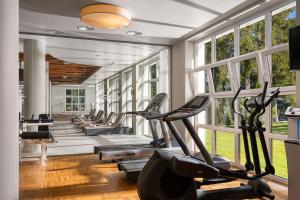 a gym with a row of treadmills and ellipticals at Ana Hotels Sport Poiana Brasov in Poiana Brasov