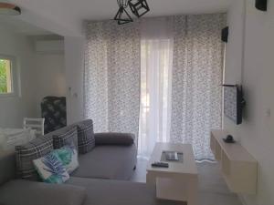 a living room with a couch and a window at Cavleski apartment in Prilep