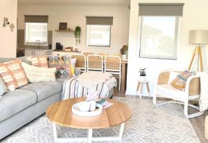 a living room with a couch and a table at Rosebud Bay Beach House in Rosebud