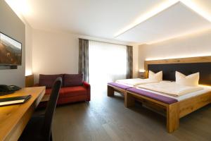 a hotel room with a bed and a desk and a desk at Hotel-Restaurant Bierhäusle in Freiburg im Breisgau +71 photos