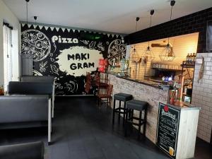 a restaurant with a chalkboard wall with a pizza makegm sign at Apartament Mąki Gram in Złocieniec