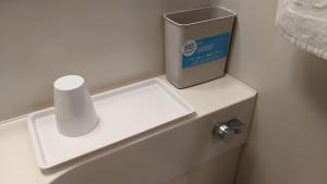 a toilet with a roll of toilet paper on top of it at Toyoko Inn Osaka Namba Nippombashi in Osaka