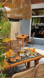 a wooden table with plates of food on it at Jony's Boutique Hotel in Boracay