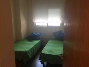 2 camas en una habitación pequeña con ventana en Preciosa vivienda en en centro de Cartagena +WiFi, en Cartagena