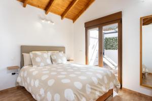 a bedroom with a large bed and a window at Casa Maria with Roque Nublo view in Tejeda