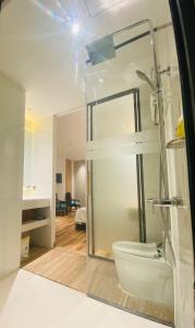 a bathroom with a shower and a toilet at Khách Sạn LUCIEN HOTEL Quy Nhơn in Quy Nhon