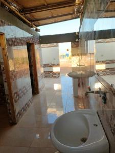 a bathroom with a toilet and a sink at Sinai Life Beach Camp in Nuweiba