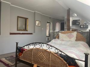 a bedroom with a wrought iron bed and a mirror at Simovic in Čačak