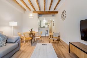a living room with a couch and a table at Apartamentos Circo Romano in Tarragona