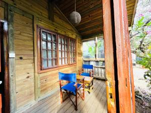 a wooden cabin with two chairs and a table on a porch at Triniti Oysterbay in Dar es Salaam
